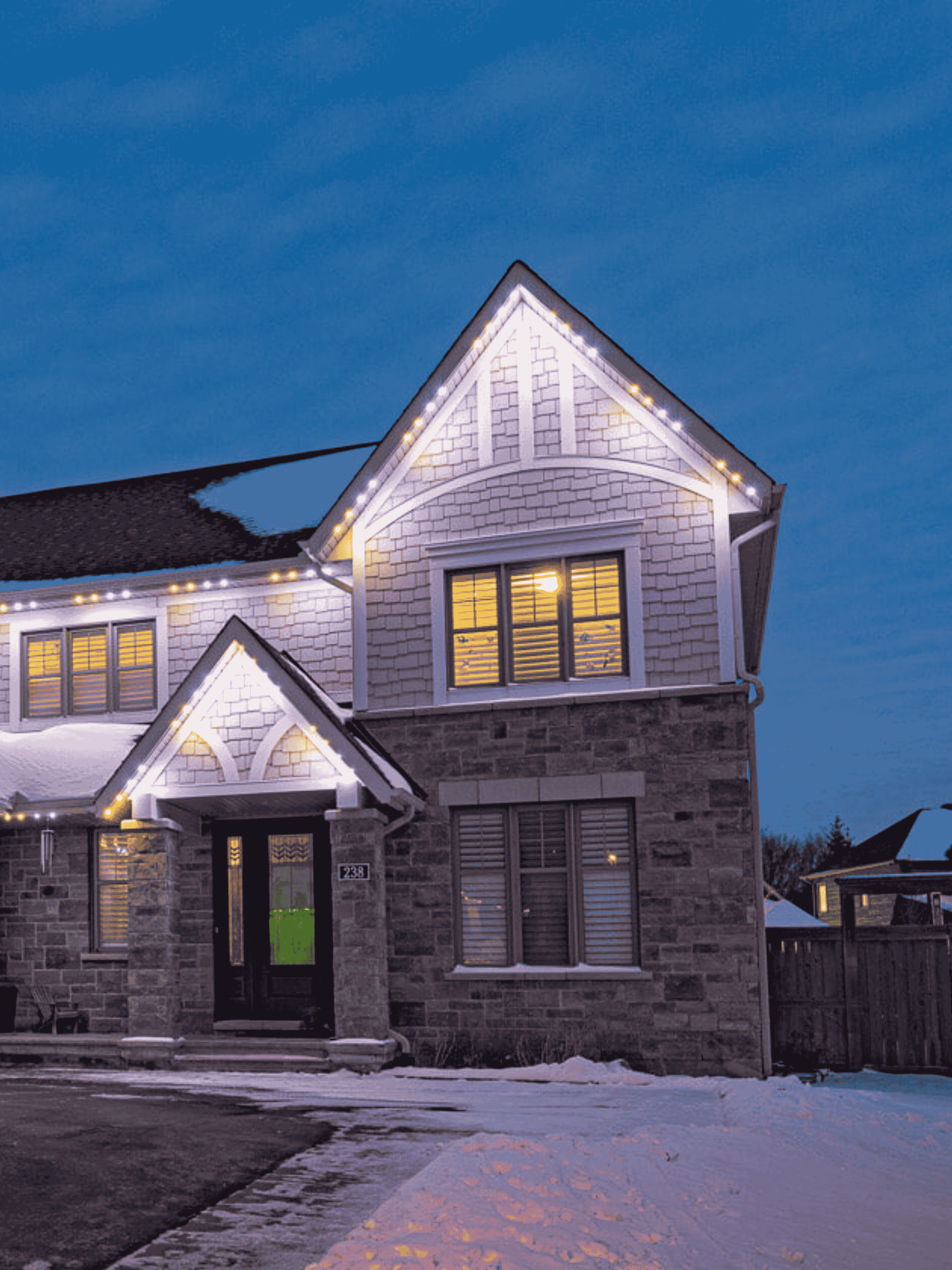 Residential exterior lit with bright white permanent LED lights highlighting ongoing support and maintenance.
